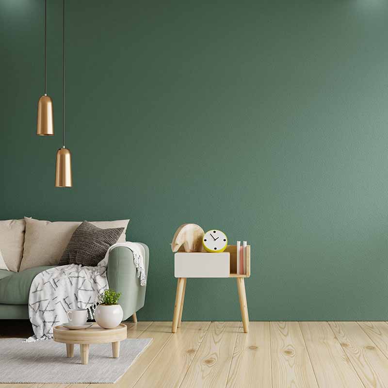 Salon avec mobilier moderne et peinture sur mur intérieur de couleur verte